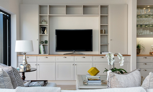 Built-in-cabinets-shelving-in-family-room Built in cabinets and shelving for storage, entertainment center, and bar in a living room