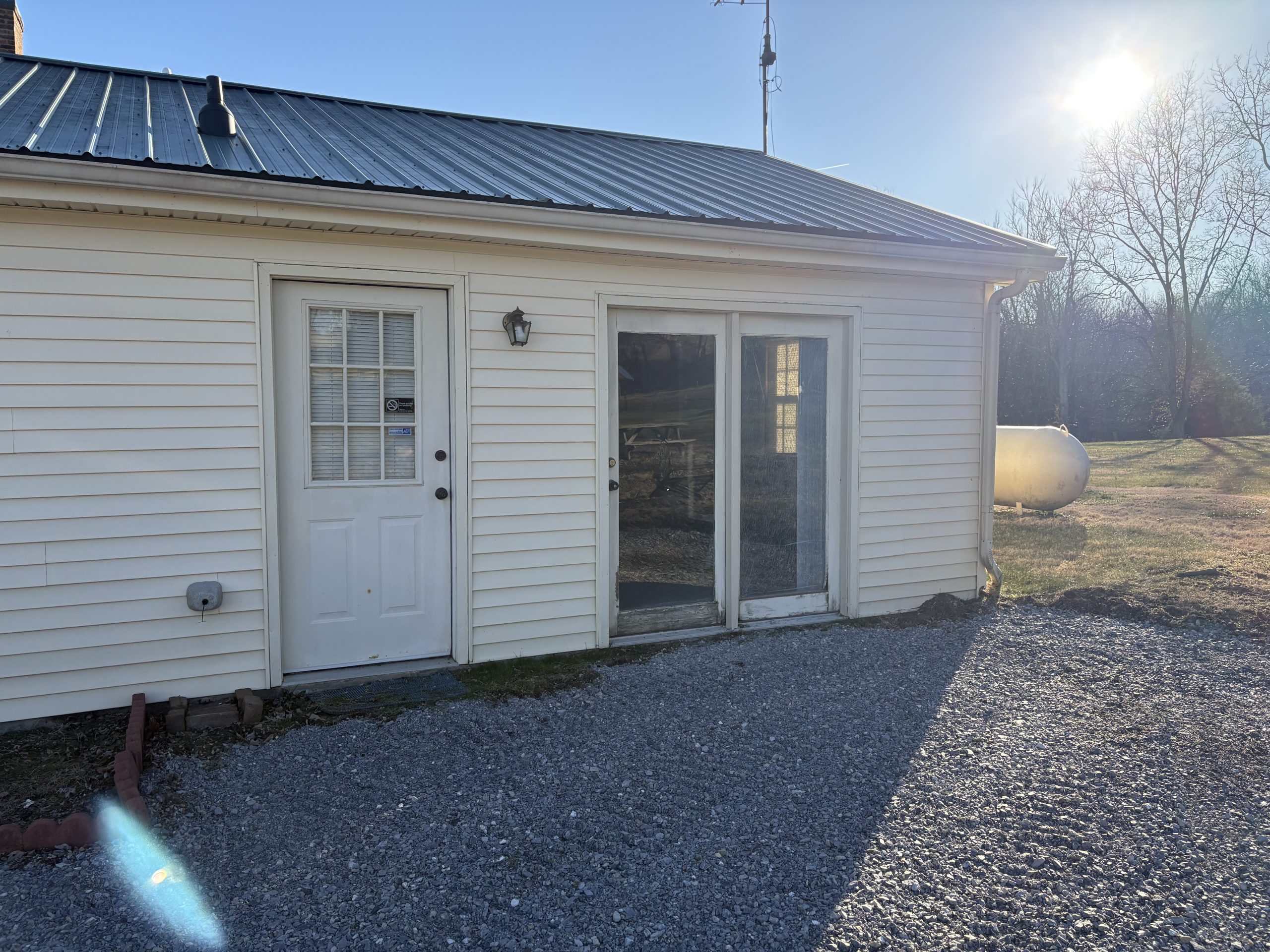 Cindy - Before An aging French door installation with the paint flaked off and the wood rotting