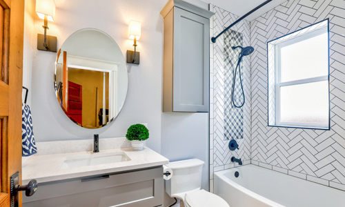 Contemporary-bathroom-remodel Bright area contemporary bathroom with fancy tile and oval mirror