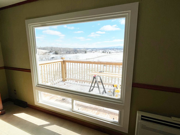 Room-remodel-with-new-picture-window-in-Greeneville-TN New flooring, paint, trim, a minisplit HVAC unit and huge new window